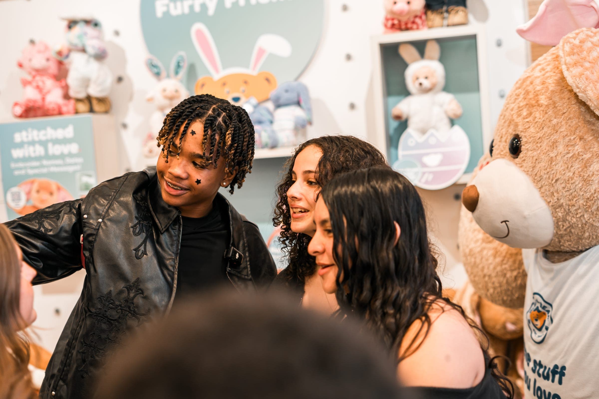 Creator in a leather jacket greeting fans inside a store