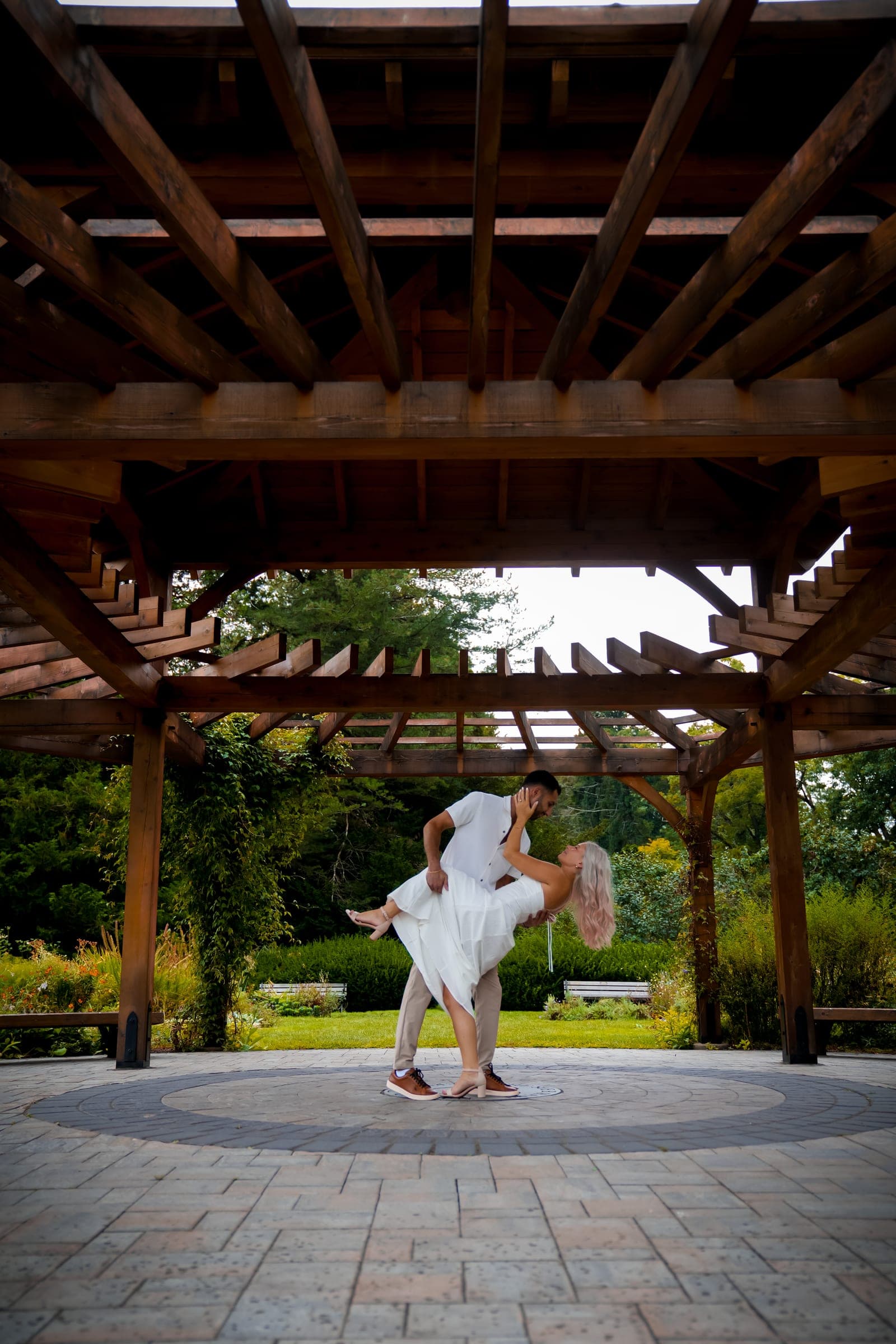 Couple in a dip beneath a wooden pergola